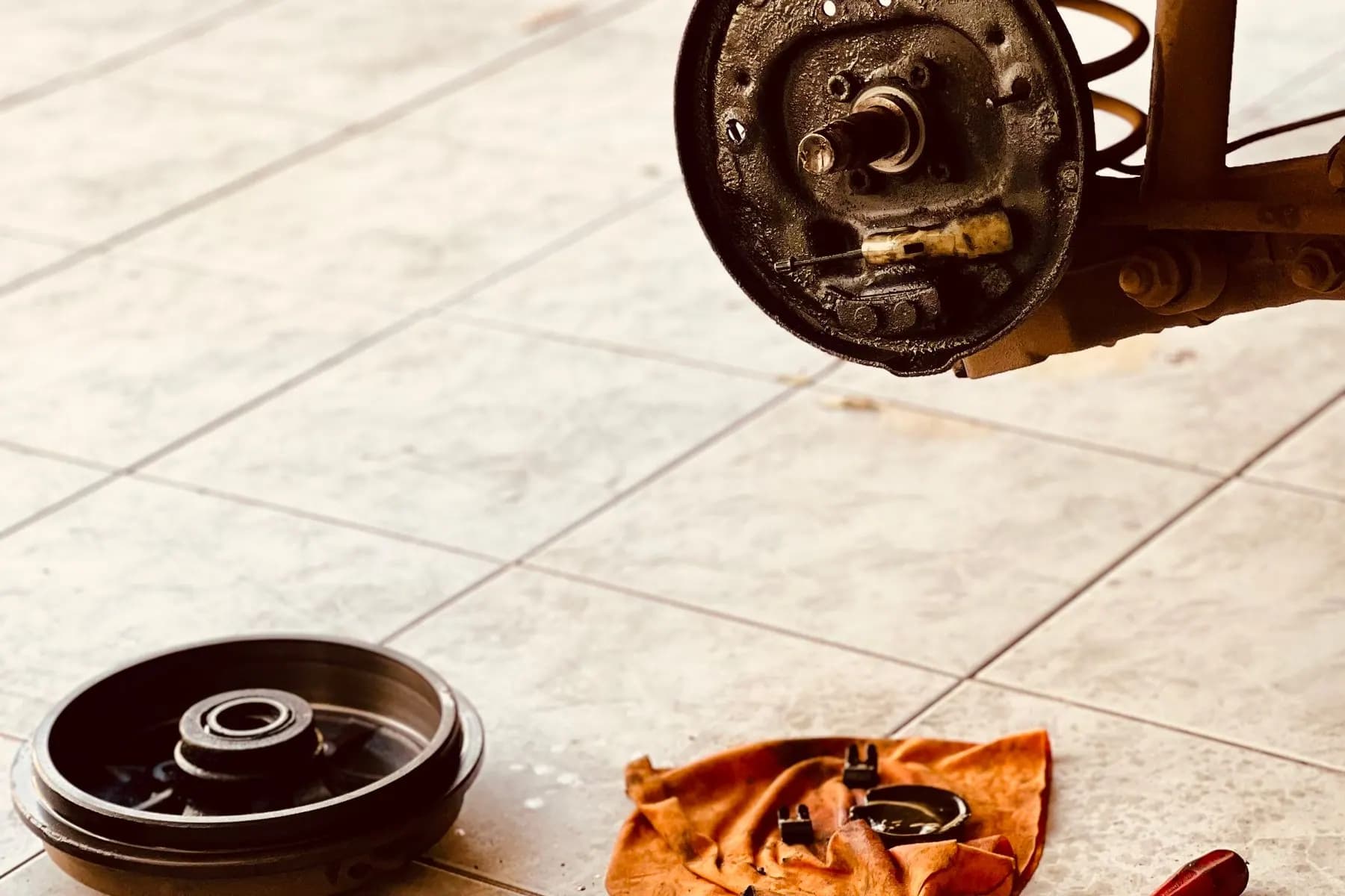 Dismantled brake system and tools for sample and specification review.
