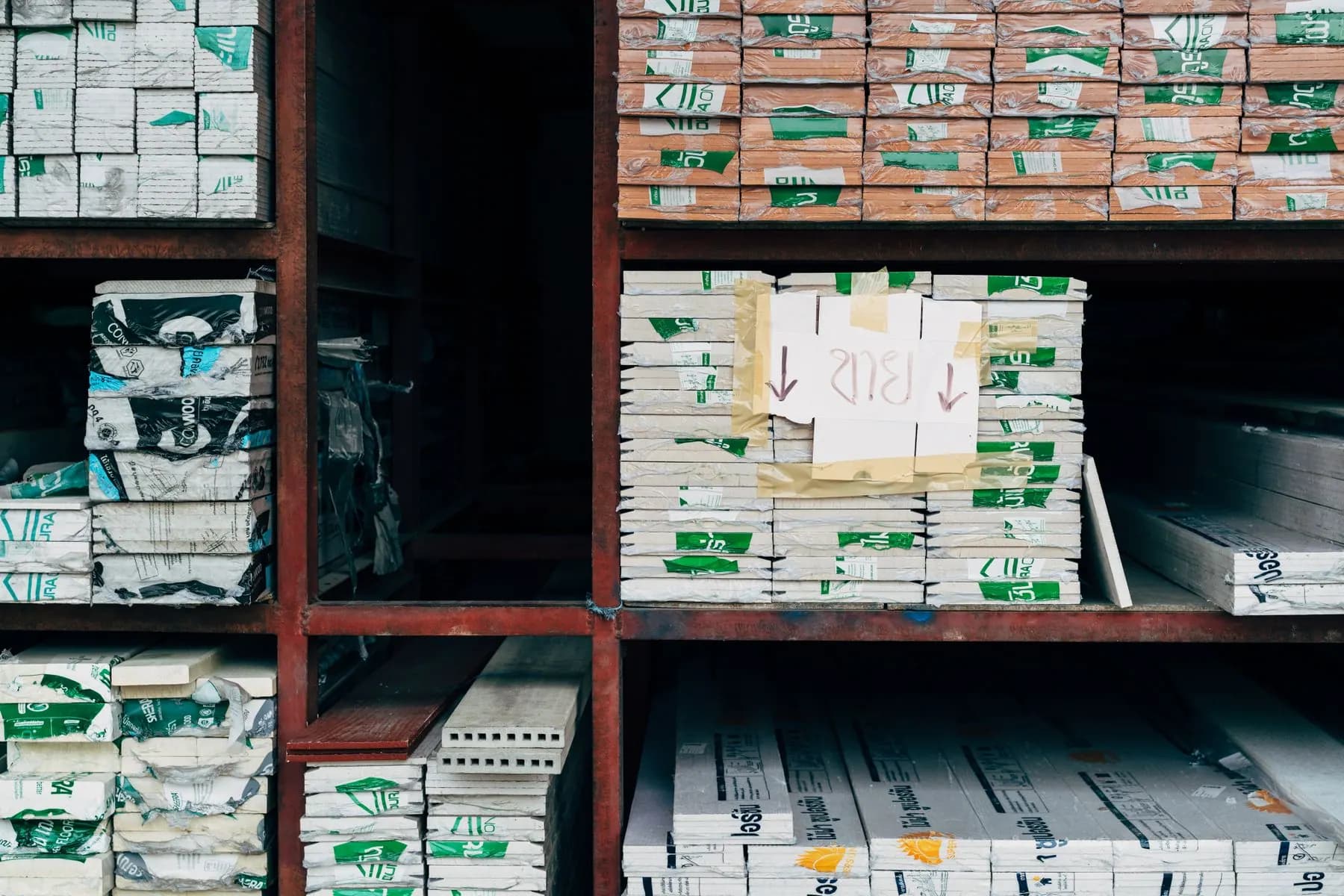 Organized building materials on warehouse shelves.