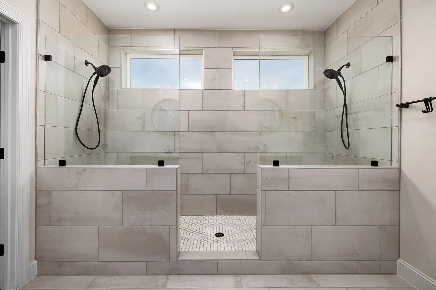 Bathroom tiles and fixtures representing material specification approval.