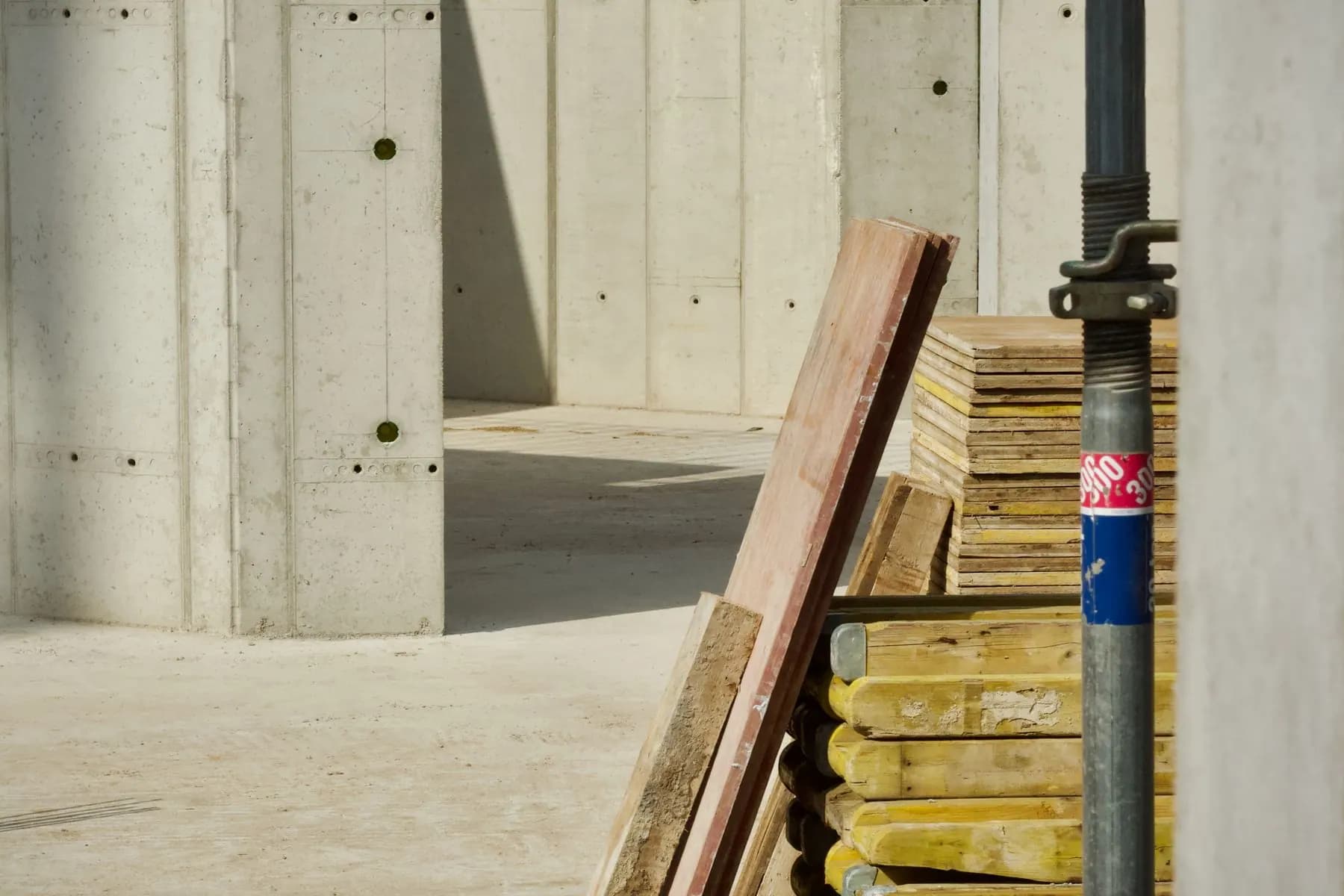 Concrete industrial site with stacked building materials.
