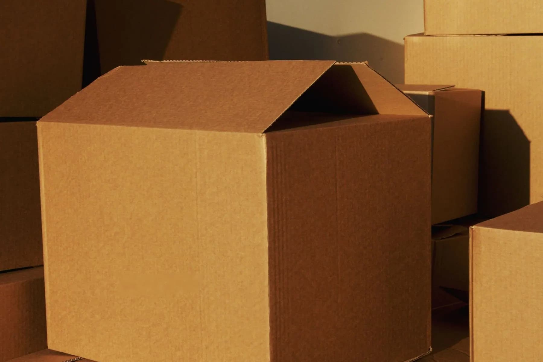 Stacked cardboard boxes for packaging and sample review.