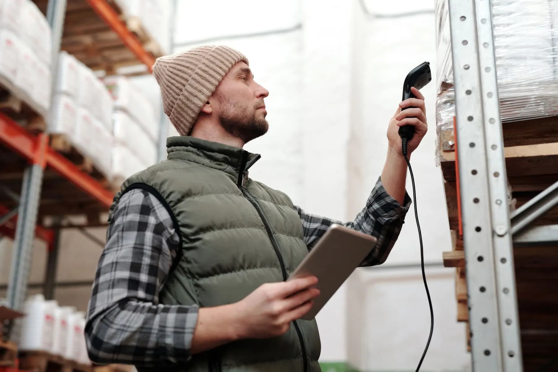 Warehouse staff scanning products for quality and inventory checks.