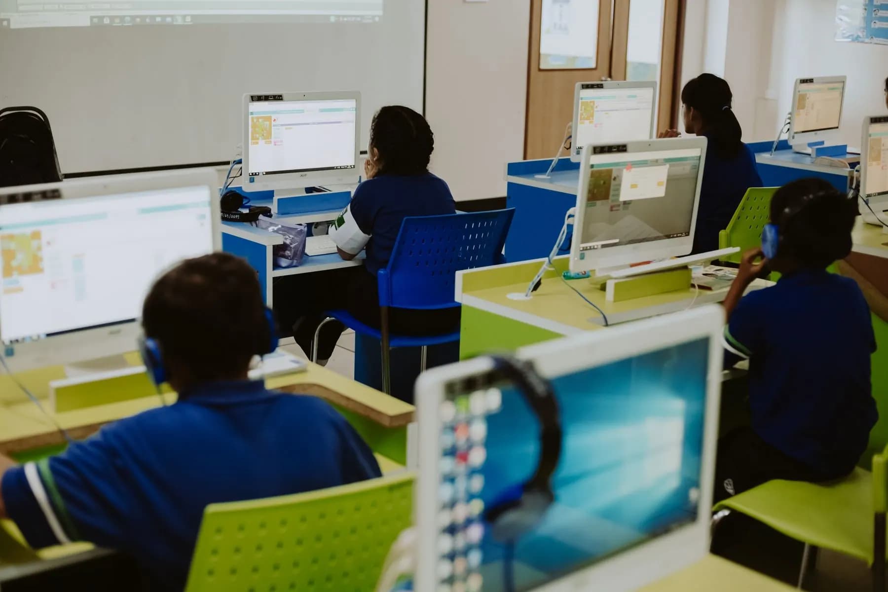 Children using computers in class for functional testing context.