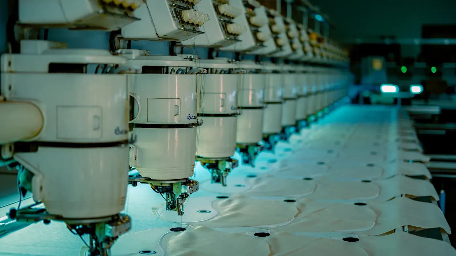 Industrial sewing machines producing garment panels.