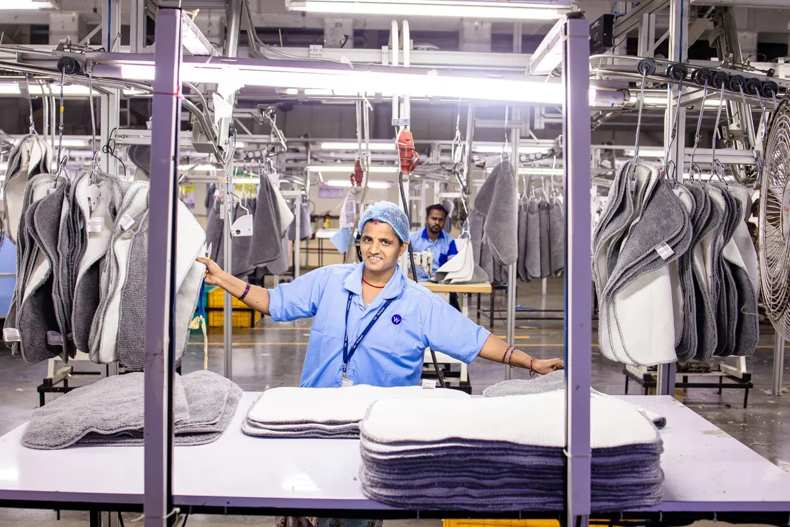 Textile quality control worker inspecting finished fabric.