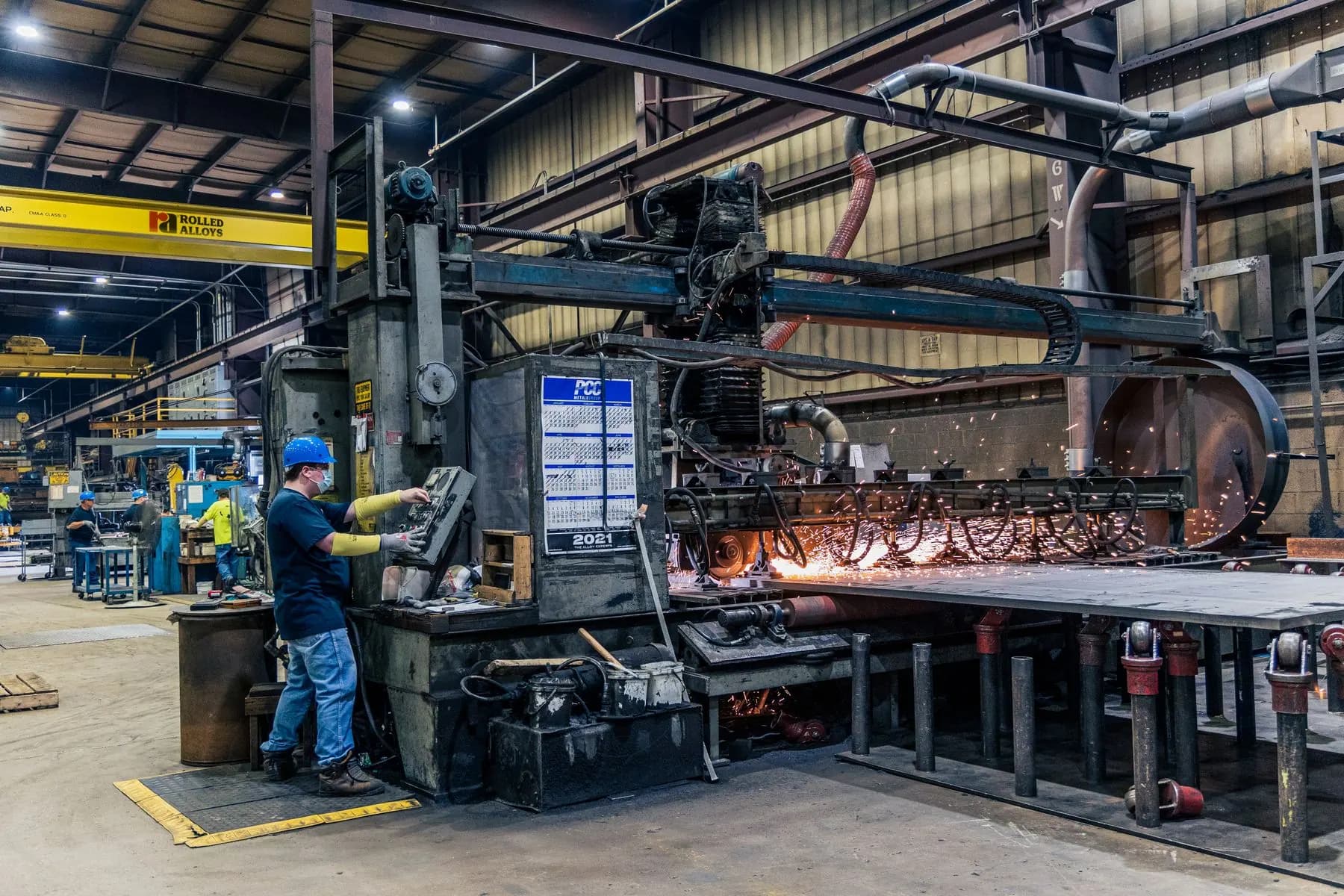 Worker operating industrial machinery in a factory.